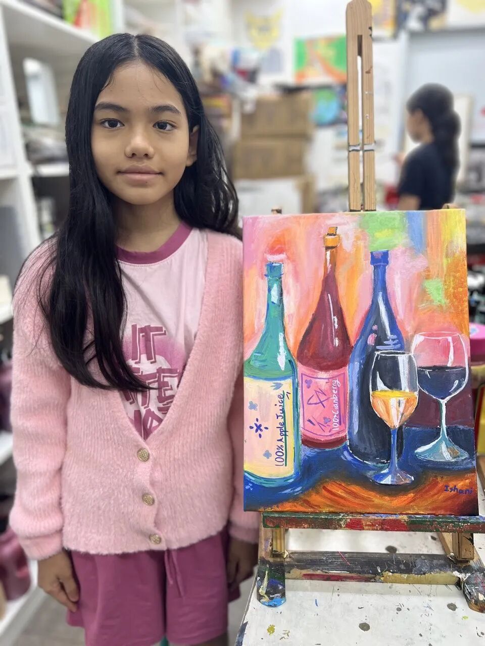 A child excitedly sharing a finished painting, illustrating a child's self-motivated creative sensitive period