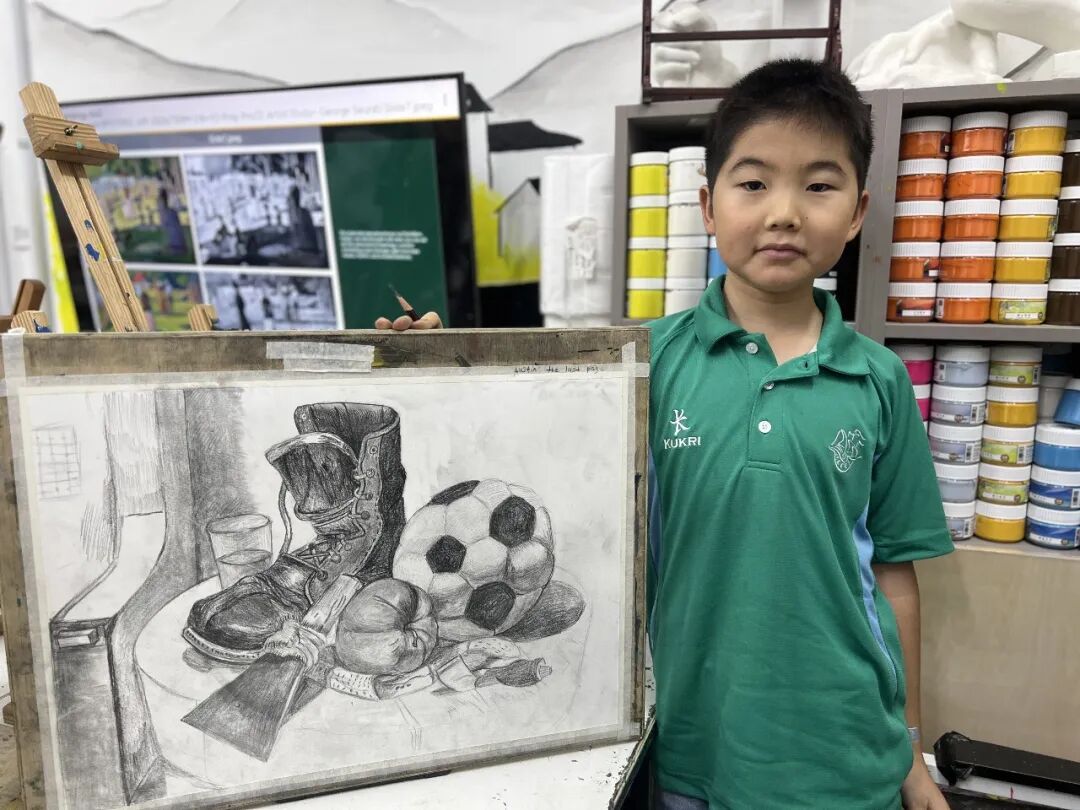 A child drawing a scene with sky, clouds, grass and animals, illustrating a child's budding aesthetic awareness after age five