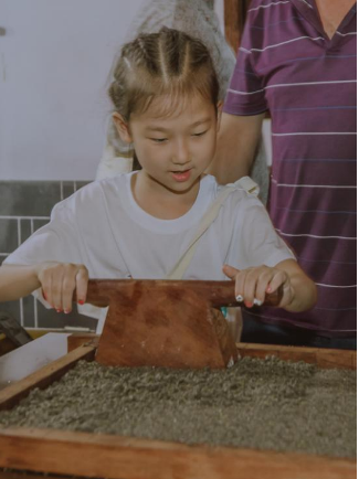 Children learning to make Huimo pastry with a master pastry chef