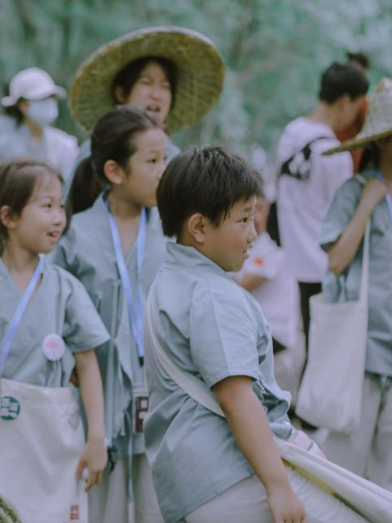 Children following clues on a village treasure hunt in Xixinan