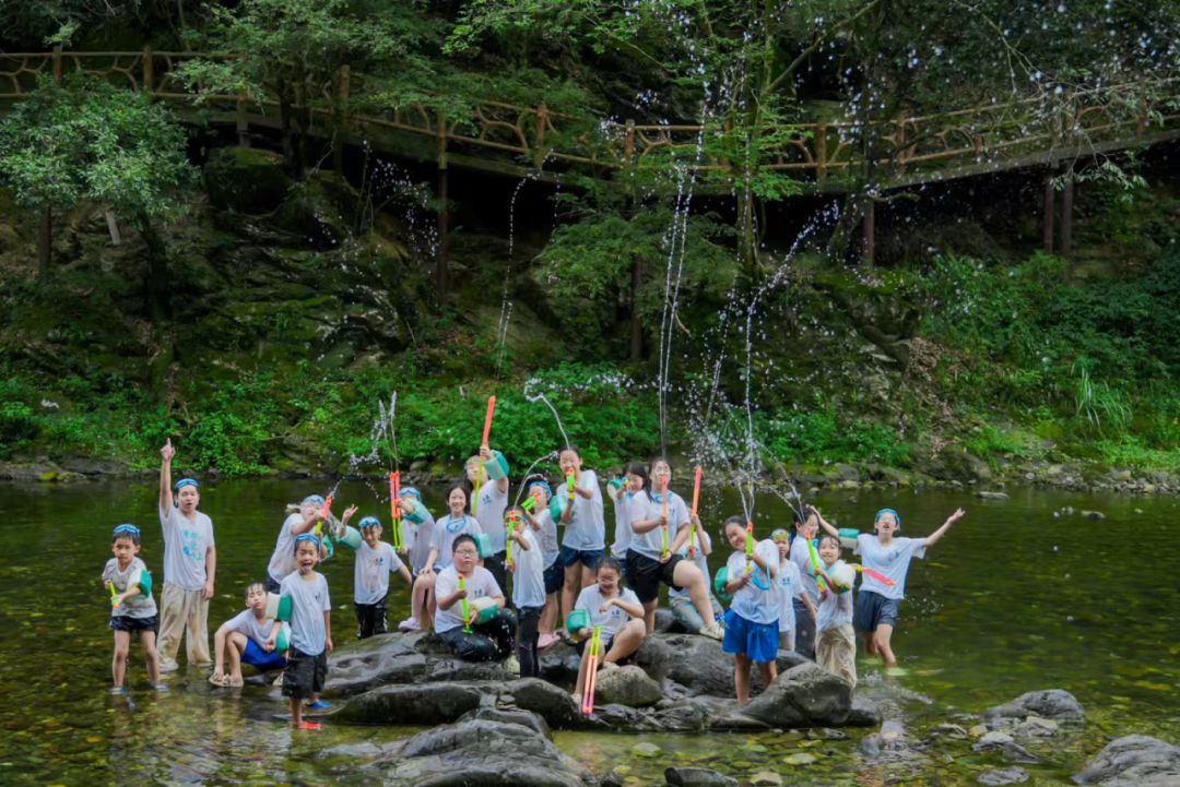 Children splashing and playing in a stream near the ancient kiln site