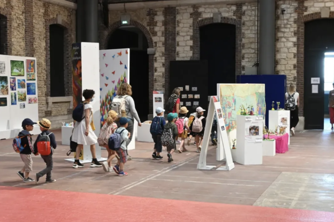 Children touring the exhibition hall where past winning artworks are displayed