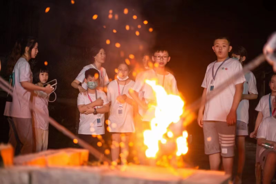 Children gathered around the bonfire for the Study Tour Night celebration