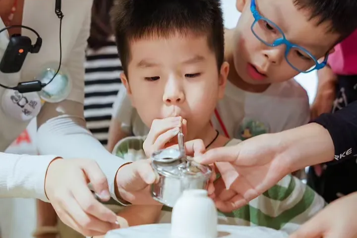 Children taking part in a hands-on ceramic craft class as part of the study tour curriculum