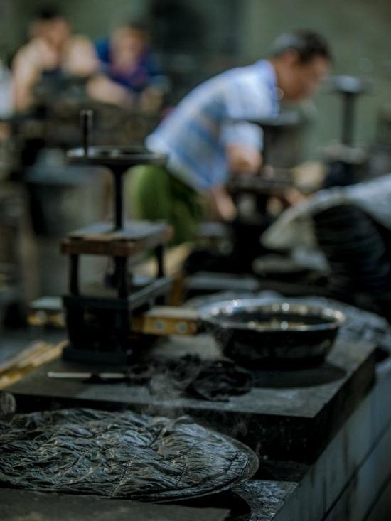 Master craftsman demonstrating traditional Hui ink making at a century-old ink factory