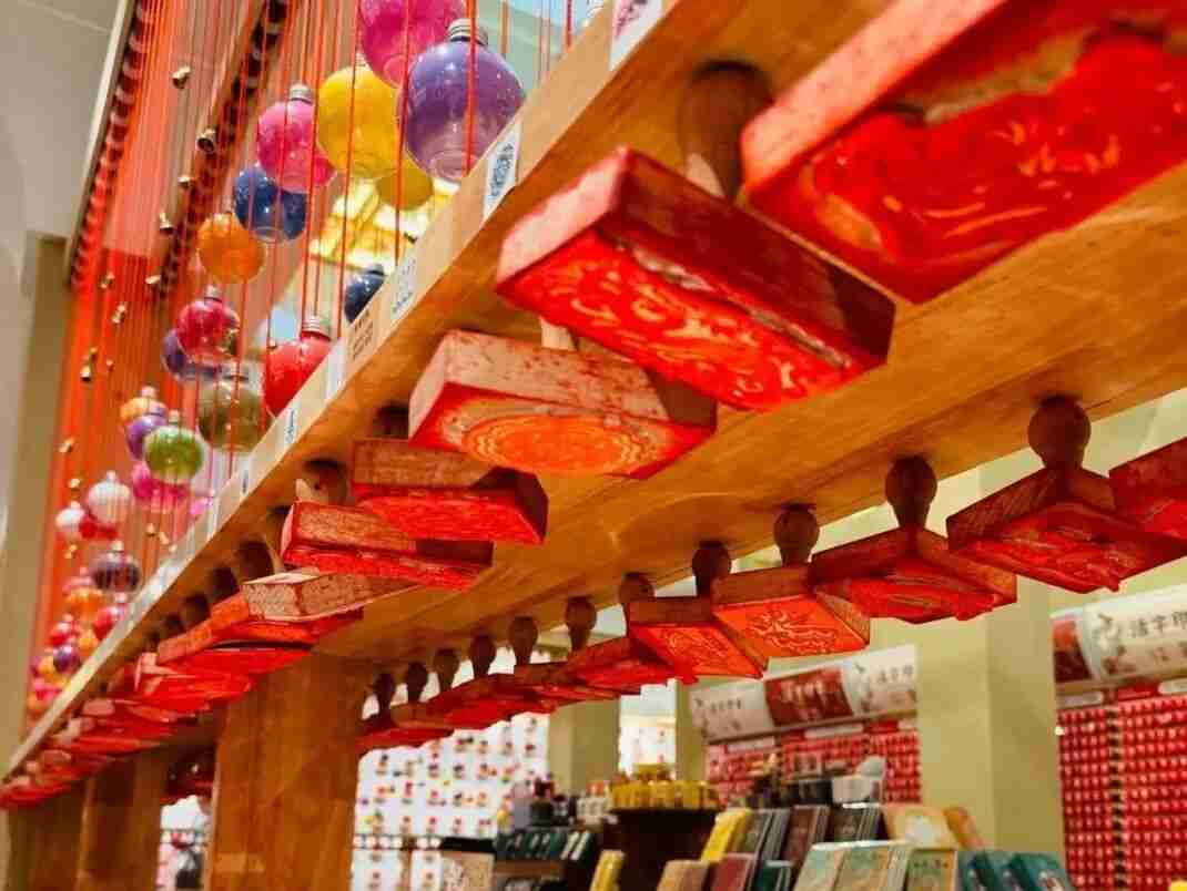 Children stamping their souvenir books at the Dunhuang Seal House