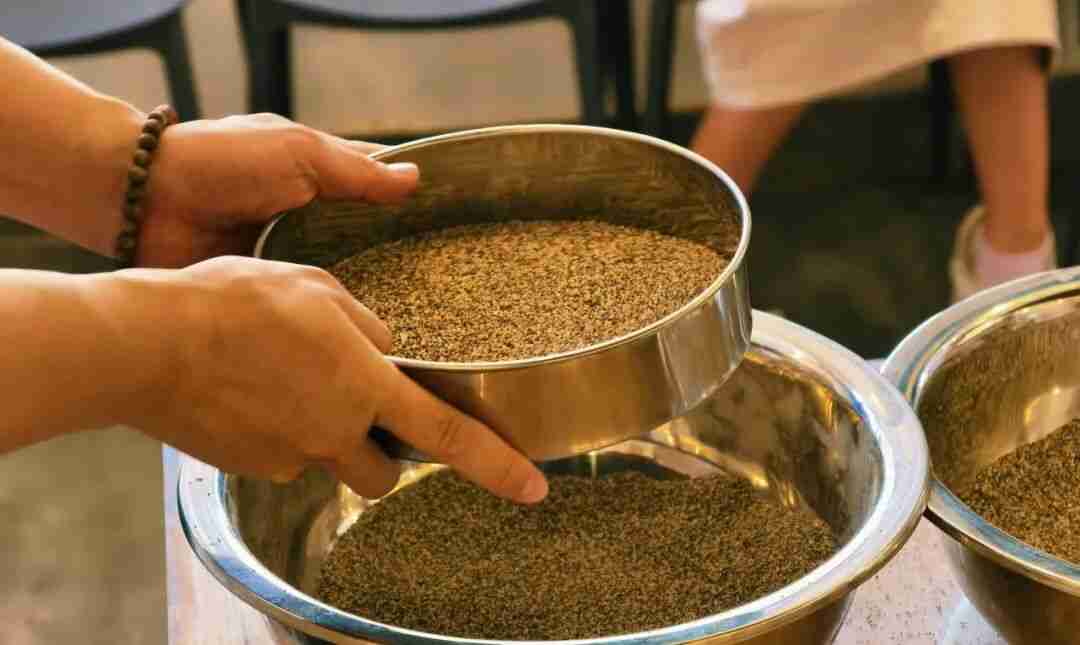 Children applying glue and sprinkling grit onto a wooden board