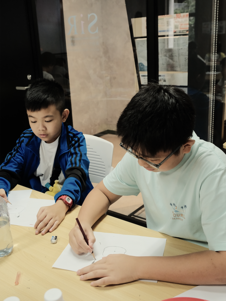 Students practising manga drawing techniques during the AMPS Anime School class