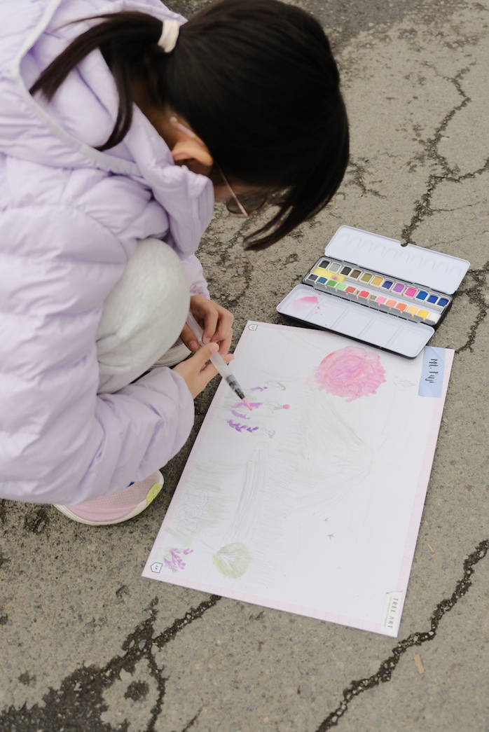Children comparing their landscape paintings of Mount Fuji and Lake Kawaguchi