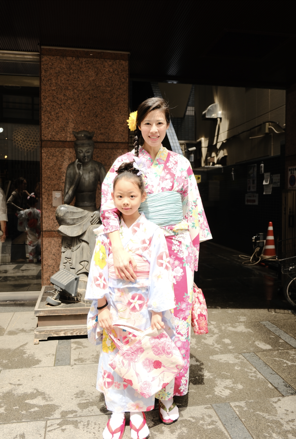 A child in a traditional kimono in front of Senso-ji, Tokyo's oldest temple
