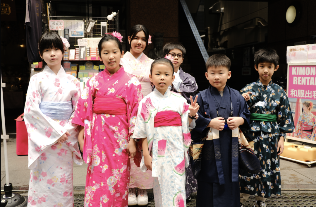 Families in kimonos exploring the temple grounds at Senso-ji