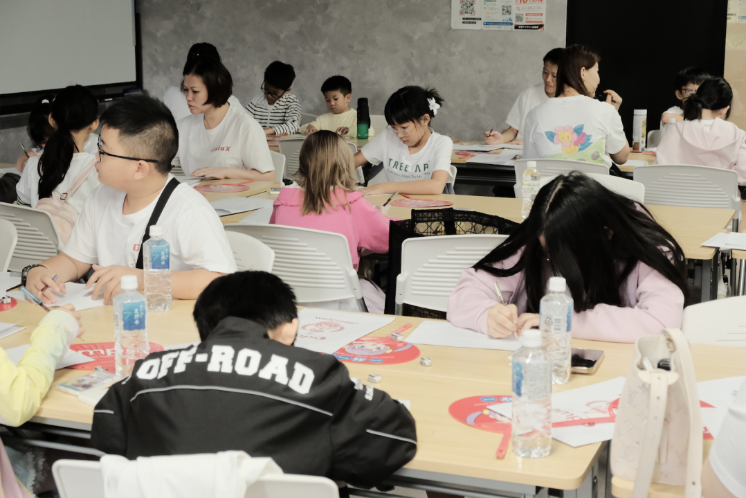 Children working on their manga artwork during the anime drawing class