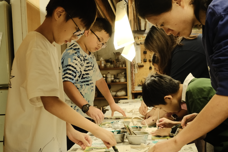 Children designing patterns for their Kyo-Yuzen dyed fabric