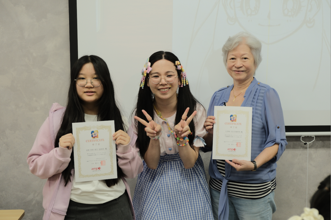 A student receiving their anime course certificate at AMPS Anime School